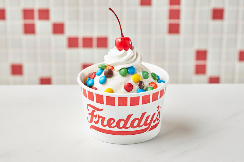Freddy’s CYO sundae with vanilla custard topped with M&M’s, whipped cream, and a cherry
