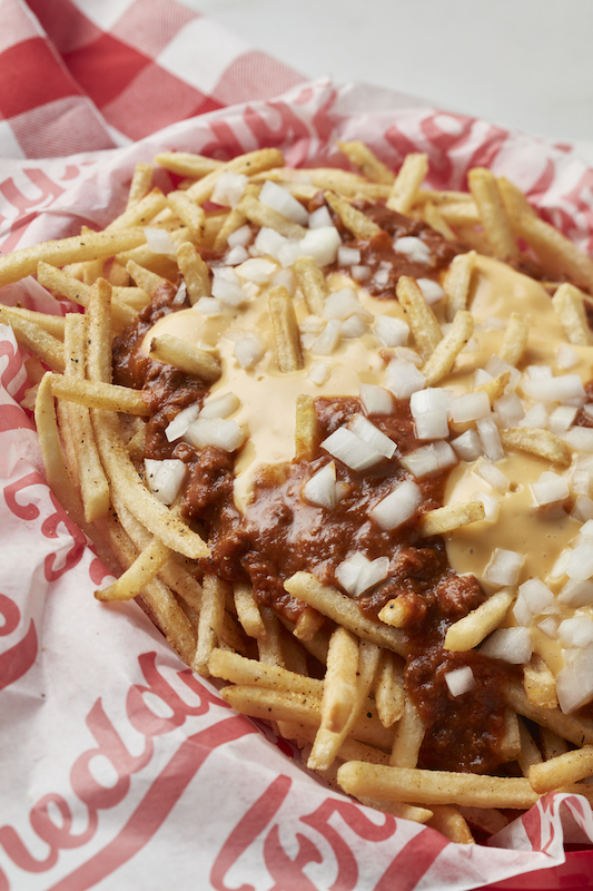 Freddy’s chili cheese fries topped with diced onions