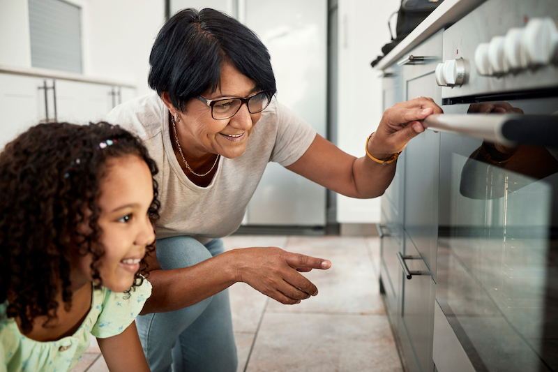 woman and child looking in oven