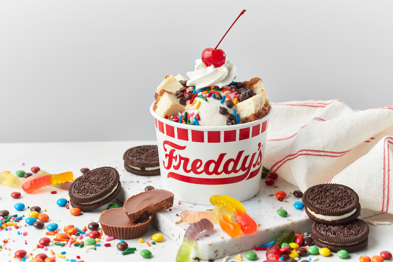 Freddy's Create Your Own Sundae topped with candy, cookies, and whipped cream