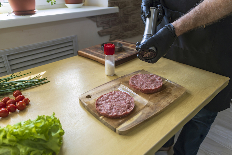 preparing burger patties on kitchen counter with seasonings