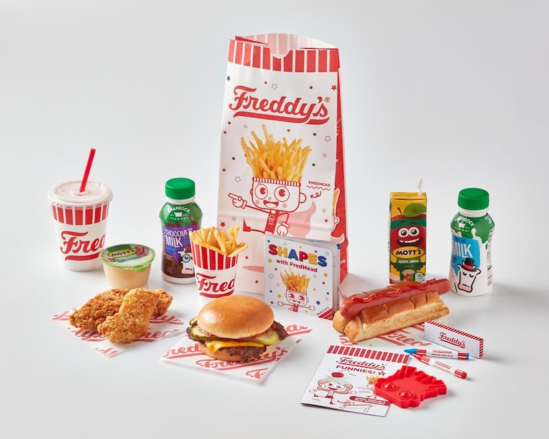Freddy’s kids meal with burger, fries, drink, milk, and fun activity items
