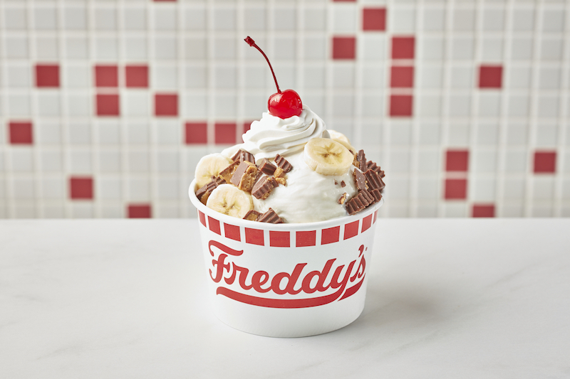 Freddy’s peanut butter bananza with banana and peanut butter cups topped with whipped cream and a cherry
