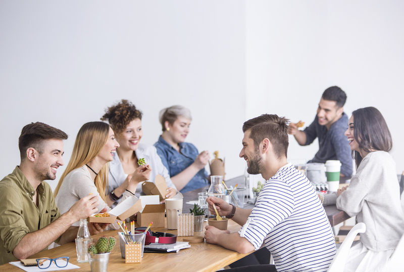 Group of coworkers enjoying catered food together
