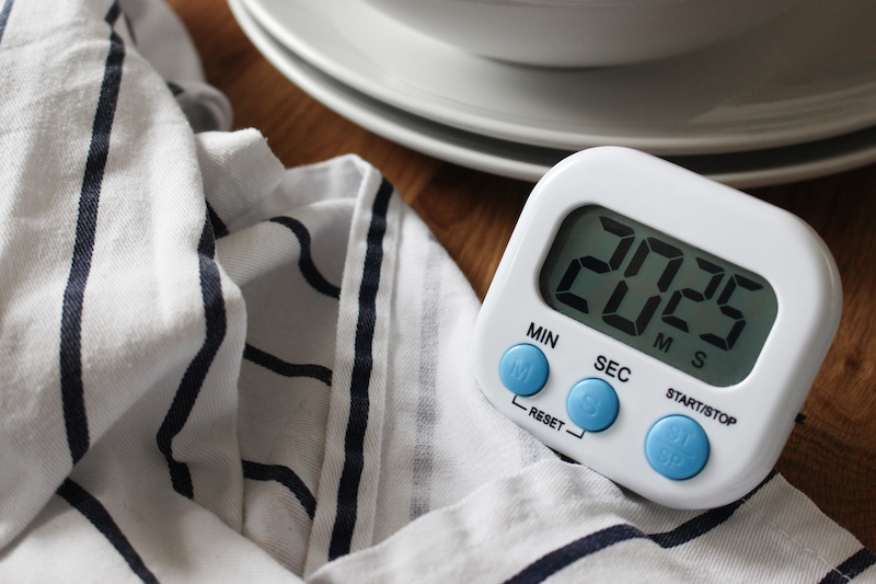 Digital kitchen timer showing 20 minutes on a countertop