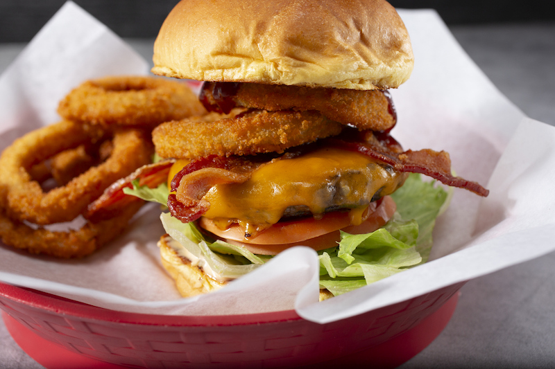 Cheeseburger topped with bacon and onion rings
