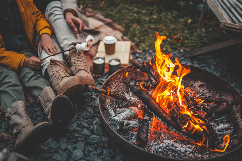 People roasting marshmallows over a campfire outdoors
