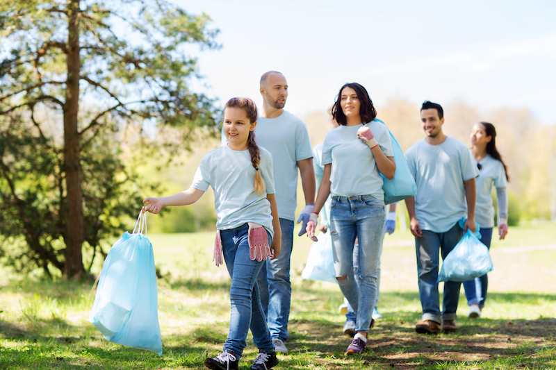 Group of volunteers picking up trash in a park