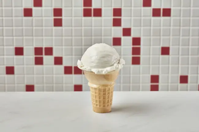 Freddy’s vanilla kids cone with a scoop of frozen custard in a wafer cone