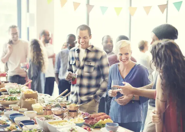 Guests enjoying food and drinks at a catered event