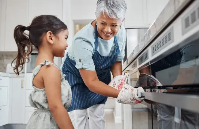 Adult and child baking together in the kitchen