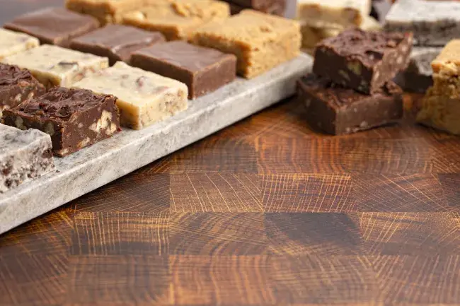 Assorted fudge squares on wooden board