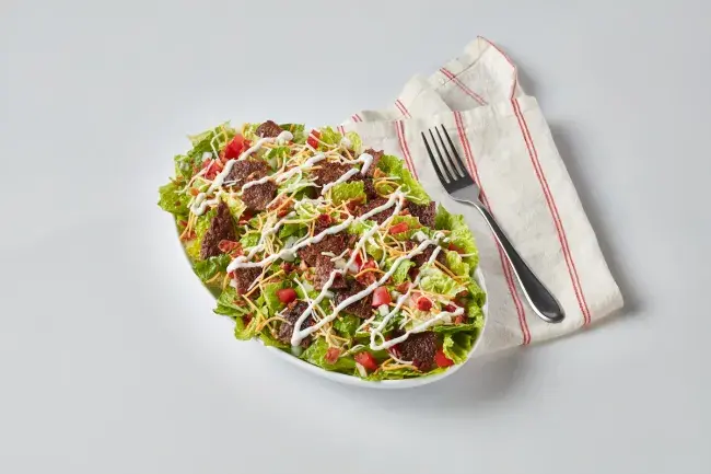 Freddy’s Steakburger Bowl with a napkin and fork