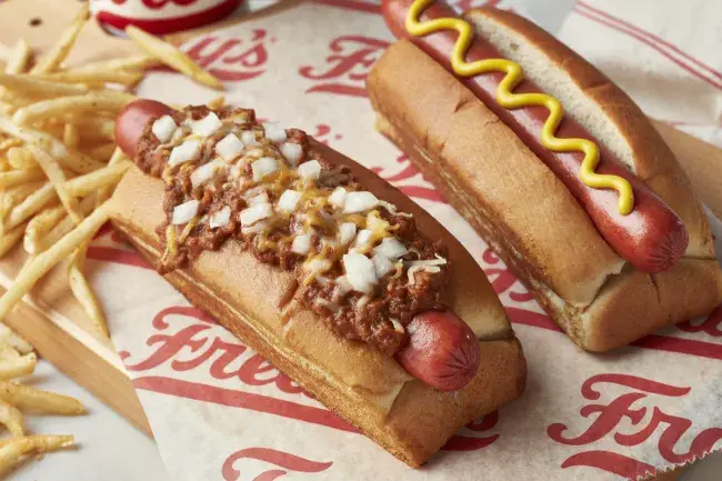 Freddy’s 2 hot dog combo served plain and topped with chili, cheese, and diced onions