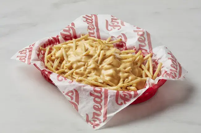 Freddy's Cheese Fries topped with cheese sauce