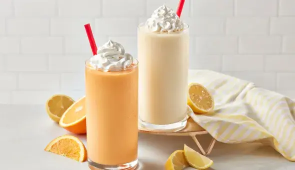 Freddy’s Orange Creamsicle and Lemonade Frosts with whipped cream and fruit slices