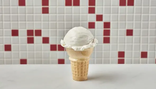 Freddy’s vanilla kids cone with a scoop of frozen custard in a wafer cone