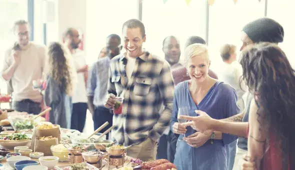 Guests enjoying food and drinks at a catered event