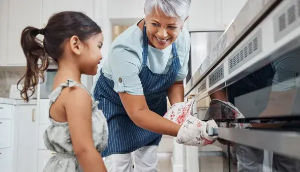 Adult and child baking together in the kitchen