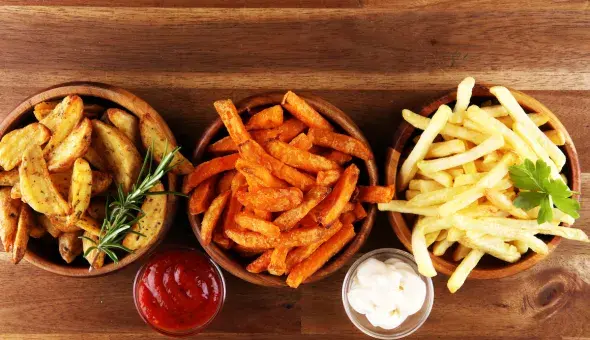 Assorted fries in bowls with dipping sauces
