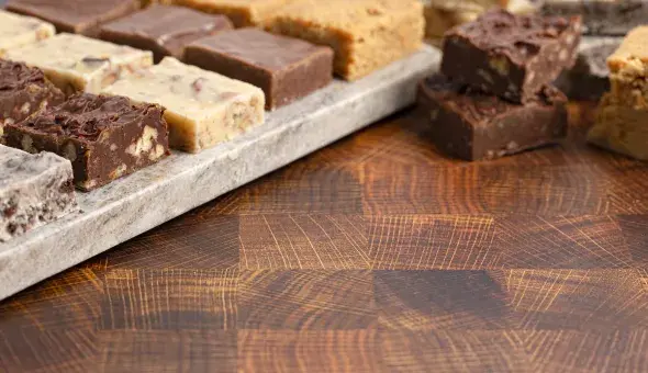 Assorted fudge squares on wooden board