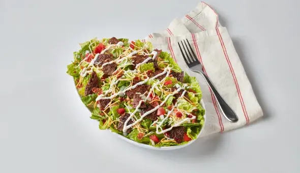 Freddy’s Steakburger Bowl with a napkin and fork