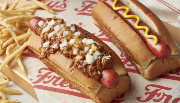 Freddy’s 2 hot dog combo served plain and topped with chili, cheese, and diced onions