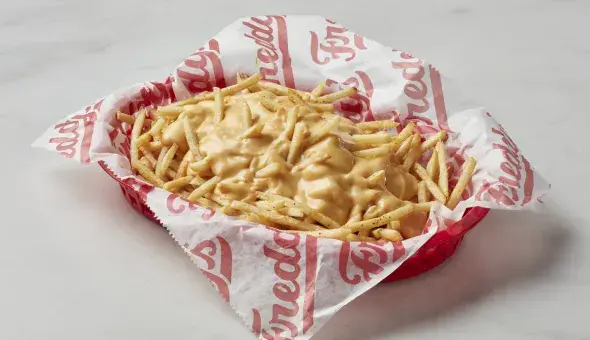 Freddy's Cheese Fries topped with cheese sauce