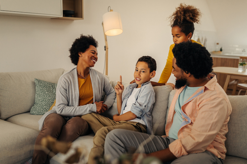 Family sitting on a couch enjoying a conversation together