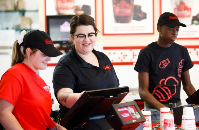 Multiple employees taking orders at the counter